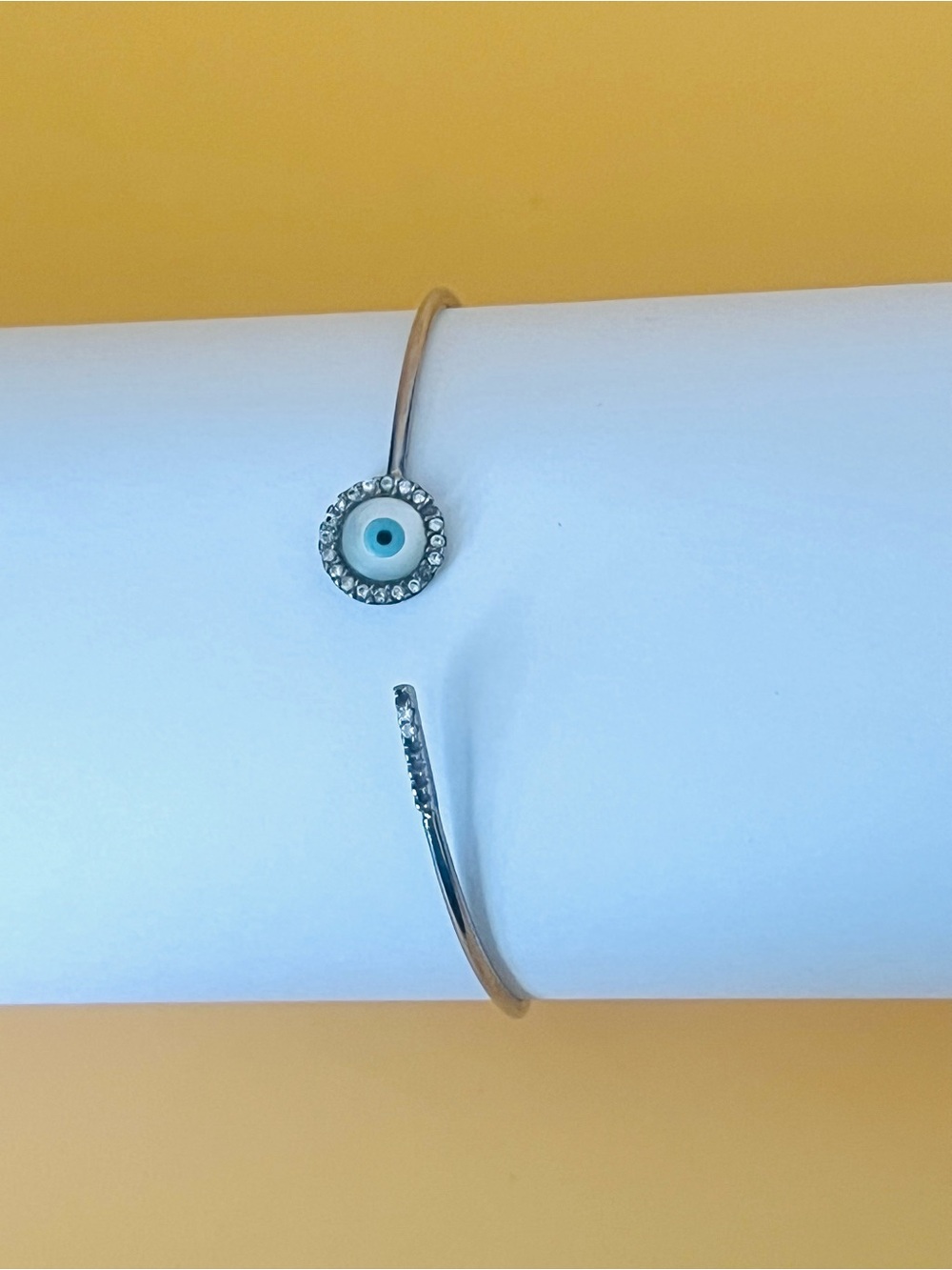 Paved clear CZ Silver bangle bracelet with a mother of pearl evil, stamped .925